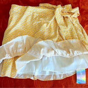Yellow wrap side tie skirt with white & blue designs..